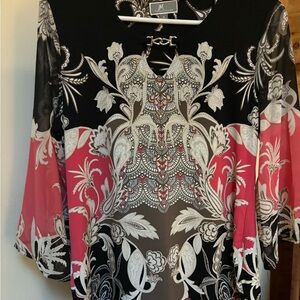 Women’s dressy blouse featuring keyhole twist on neckline.